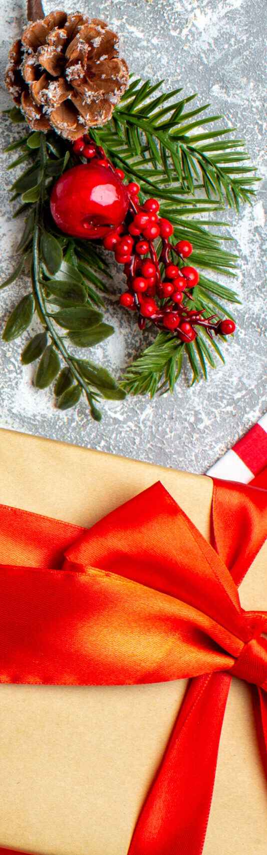 top-view-new-year-written-notebook-xmas-gifts-cereal-jar-grey-table