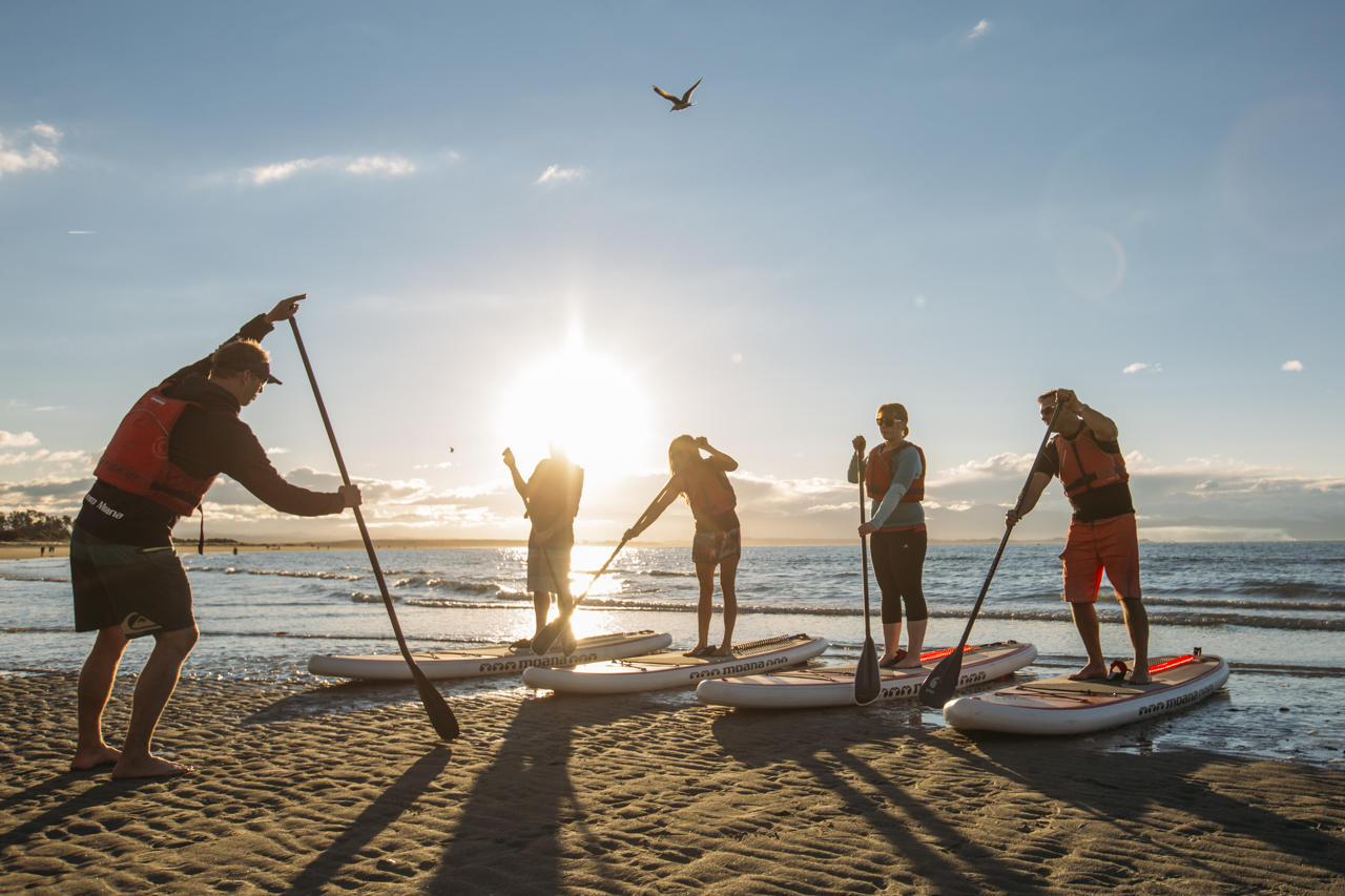Learning to paddleboard on Tahunanui beach