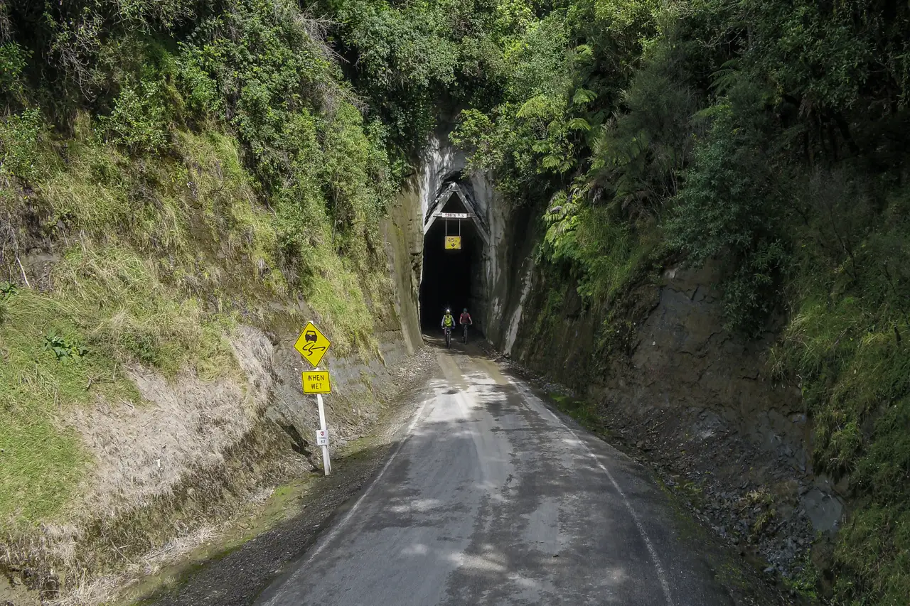 Cyclists on the Forgotten World HighwayMoki Tunnel
